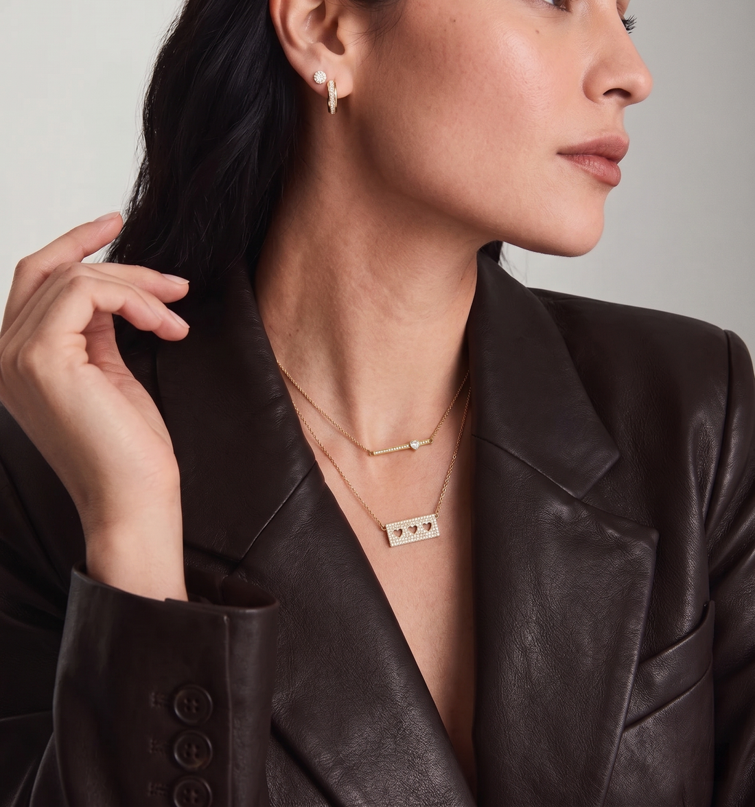 Layered necklaces styled together with meaningful pendants